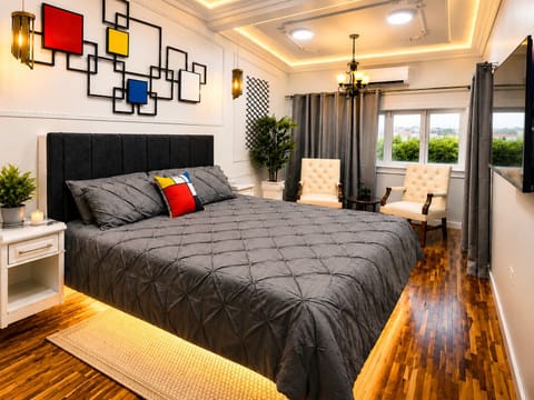 King bedroom with floating bed, closet, private balcony access & sunrise views