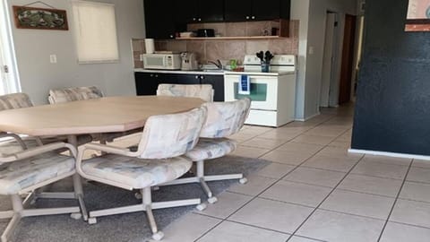 Open dining and kitchen area with tile flooring