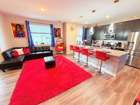 Bright main living space with bold decor, comfy seating, and plenty of room to relax together.