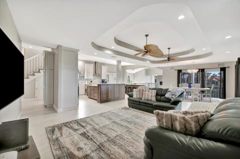 Open-Concept Living Room Flowing into Chef’s Kitchen and Island Seating