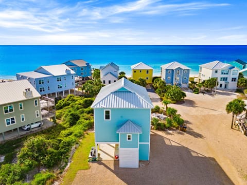 Colorful beachfront homes create a charming coastal community just steps from pristine white sand and turquoise waters.