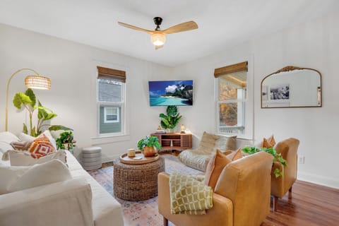 Southern-vintage boho living room with woven accents and a 55" mounted TV.