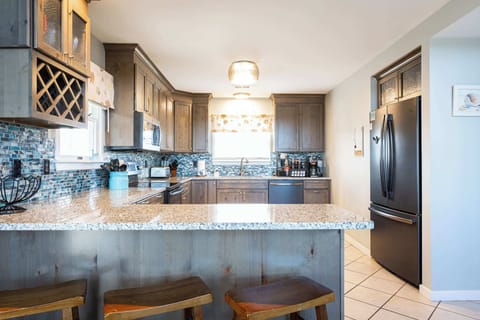 Top Level: Fully Stocked Kitchen w/ Refrigerator, Dishwasher, Toaster, Oven, Microwave, Stove, Toaster, and Cooking Utensils with Breakfast Bar