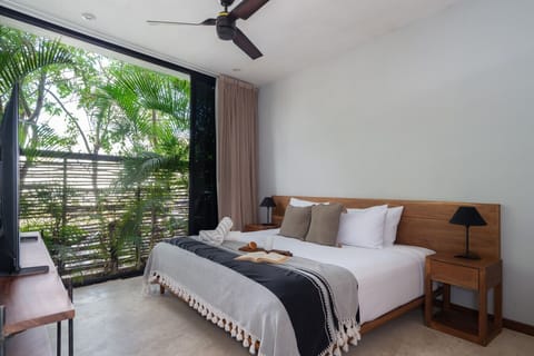 Calm bedroom with king bed, soft light, and relaxing views.