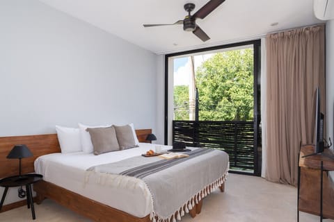 King bed, wide window, AC, and bright natural light for a comfy stay.