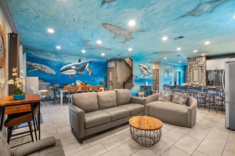 Living room in an open floor plan concept with the dining area and kitchen