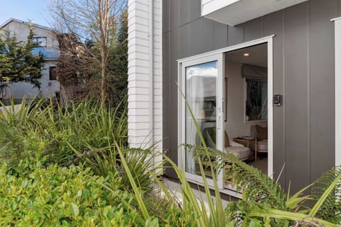 Private entrance with lush garden surroundings.