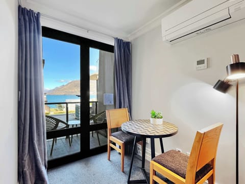 Dining nook by the balcony doors, perfect for meals with fresh air and lake views.