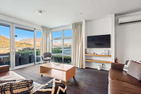 Lounge opens onto patio with stunning lake and mountain views.