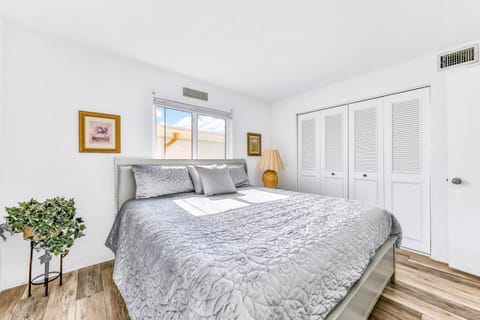 Relax in this serene beach stay bedroom featuring a plush king bed, soft natural light, and calming coastal décor—perfect for unwinding after sun-filled days by the shore.