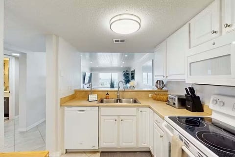 Enjoy the ease of your beach stay in this open, fully equipped coastal kitchen. Featuring modern appliances, generous counter space, and a bright layout that flows seamlessly into the living area—perfect for relaxed seaside living.