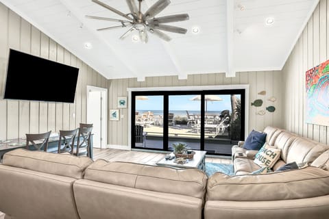 Relax in this open, sunlit living space designed for the ultimate beach stay. Enjoy comfortable seating, coastal décor, and sliding doors that open to ocean views, blending indoor comfort with laid-back seaside living.