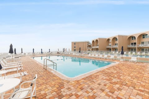 Unwind by the spacious oceanfront pool with plenty of lounge chairs and stunning coastal views. Perfect for a relaxing beach stay, this resort-style pool deck is just steps from the sand, offering the ideal blend of sunshine and seaside comfort.