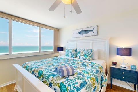 Wake up to stunning oceanfront views in this bright master bedroom. Coastal décor and a plush king bed create the perfect beach-stay escape for relaxation and comfort.