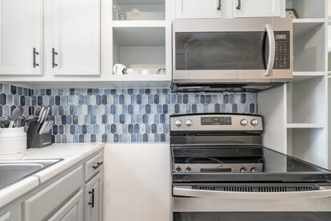 Unit 1: Essentially equipped kitchen, complete with stainless-steel appliances and a dining area for 2 guests.