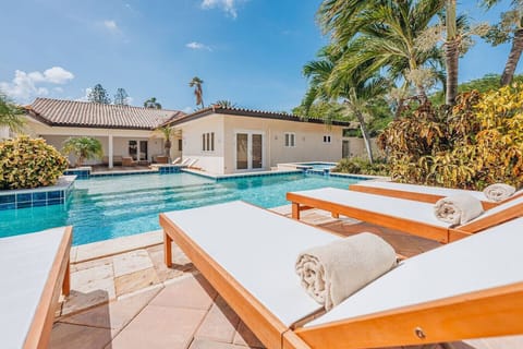 Sun-soaked pool, luxurious relaxation.