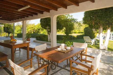 Shaded outdoor dining space overlooking the garden, perfect for morning coffee or evening meals. Just 22km from Ancient Olympia!