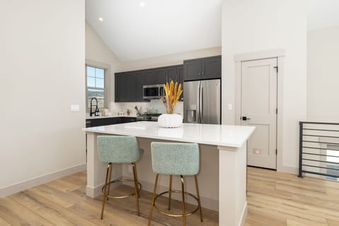 Your modern kitchen features sleek countertops, stainless steel appliances, and a breakfast bar perfect for morning coffee.