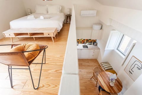 The living spaces are divided into 3 distinct areas: 
- the kitchen / dinning area
- the mezzanine, functions both as a second bedroom and lounge area
- the rooftop terrace