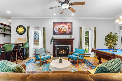 Cozy up by the fireplace or enjoy a friendly game of pool in this stylish lounge featuring vibrant décor, comfy seating, and a built-in bar—perfect for relaxing or entertaining.