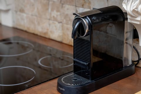 The coffee machine on the counter lets guests start their day with a fragrant brew without leaving the house.