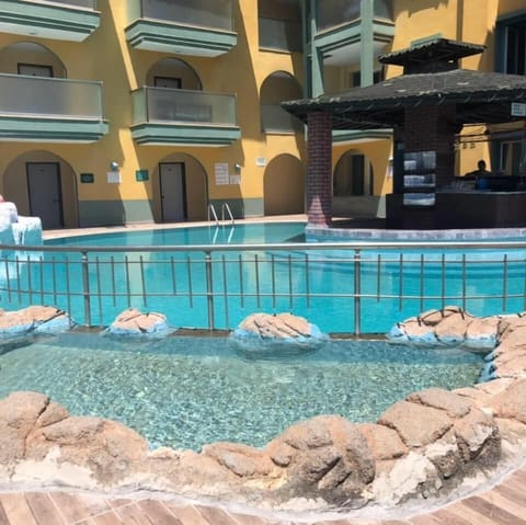 Seasonal outdoor pool, open 8:00 AM to 8:00 PM, pool umbrellas