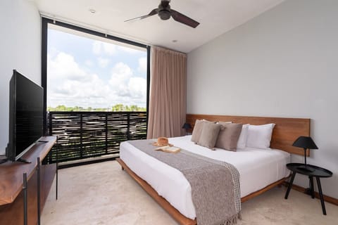 Bright studio with king bed, natural light, and cool AC for a relaxing stay.