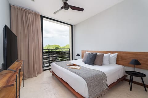 Spacious bedroom with king bed, natural light, and stunning views.