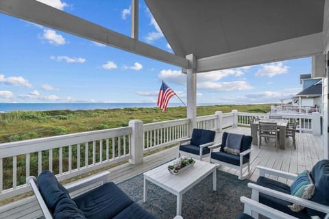 Spacious beachfront balcony with outdoor seating, Gulf views, and coastal lounge area – Bolivar Peninsula vacation rental with oceanfront deck