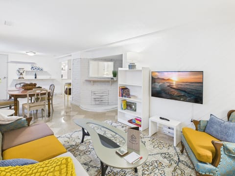 Welcome to your cozy boutique living space with 43" Smart TV featuring vibrant yellow and blue accents!