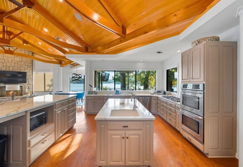 Spacious kitchen with large island and vaulted wood beams.