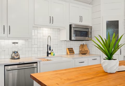 Fully equipped kitchen with stainless appliances and farmhouse-chic charm.