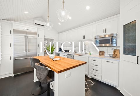 Modern kitchen with island seating and butcher-block counters—chef ready!