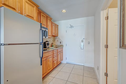 Fully stocked kitchenette with granite counters and stainless appliances—perfect for preparing quick meals during your beach stay. Conveniently located near the entry for smooth vacation living.