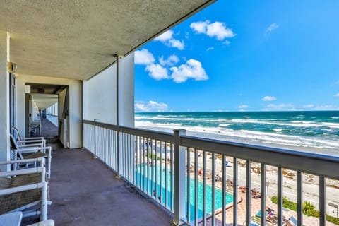 Take in sweeping ocean views during your beach stay from this oceanfront balcony, overlooking the sandy shoreline and sparkling pool—perfect for relaxing, people-watching, and soaking up coastal breezes.