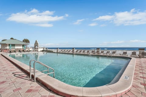 Enjoy this stunning beach stay pool area overlooking the ocean, featuring plenty of lounge seating and crystal-clear water—perfect for soaking up the sun and relaxing by the shore.