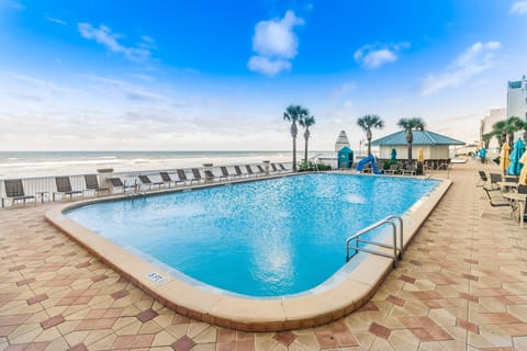 Enjoy this sparkling beach-stay pool overlooking the ocean, complete with plenty of lounge seating and palm-fringed views—perfect for sunbathing, swimming, and soaking up the coastal breeze.