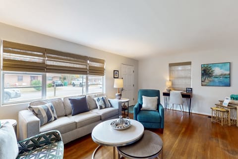 Sunlit living room with cozy seating, beach-inspired décor, and an open layout—perfect for relaxing, gathering, and enjoying downtime after a fun-filled, unforgettable beach stay.