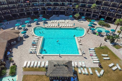 Spacious resort-style pool area with ample loungers, umbrellas, and tropical vibes. Perfect for soaking up the sun or relaxing between beach adventures during your unforgettable beach stay.