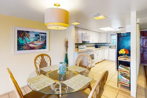 Enjoy meals in this welcoming beach stay dining area, perfectly connected to a bright, fully equipped kitchen. Coastal accents and an open layout make it ideal for relaxing, dining, and gathering after a fun-filled day at the beach.