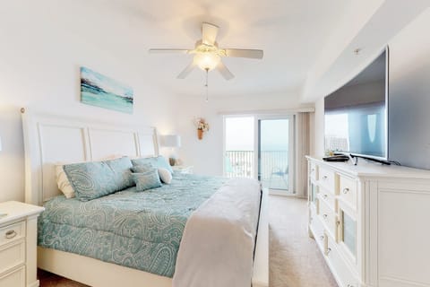 Unwind in this serene coastal bedroom featuring beach-inspired décor, plush bedding, and balcony access with ocean views—perfect for a relaxing beach stay after sun-filled days by the shore.