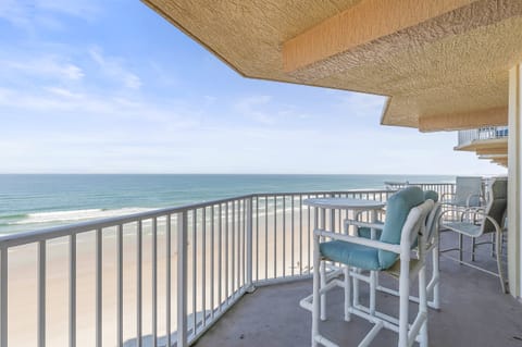 Relax on your private oceanfront balcony overlooking pristine sandy shores and endless blue water.