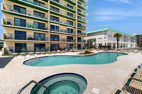 Enjoy your beach stay with access to this resort-style pool and hot tub, surrounded by lounge seating and palm trees. Perfect for relaxing after a day on the sand, just steps from the ocean.
