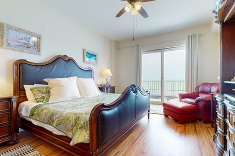 Rest easy in this spacious oceanview bedroom featuring a comfortable bed, cozy seating, and private balcony access. A serene retreat for your beach stay, with calming coastal décor and soothing sea views to start and end your day.