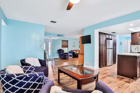 Gather and unwind during your beach stay in this open living area with comfortable seating, coastal décor, and easy flow to the kitchen—perfect for relaxing together after sunny days at the shore.