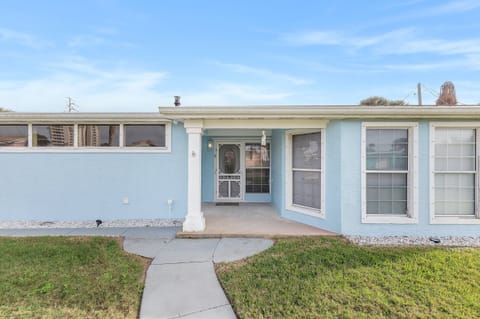 Arrive in style for your beach stay at this charming coastal home featuring a covered entry, soft blue exterior, and inviting walkway—setting the tone for a relaxing seaside getaway just minutes from the beach.