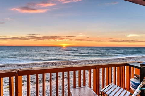 Warm sunset light melts into the horizon as you unwind on your private deck, listening to the gentle roll of waves.
