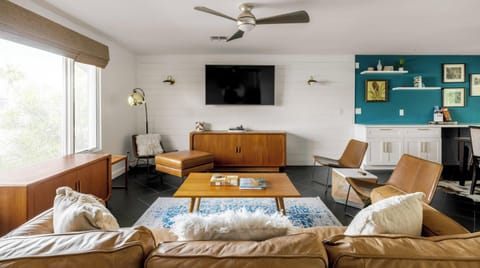 Mid-Century Modern Living Room with Multiple Seating Options and TV