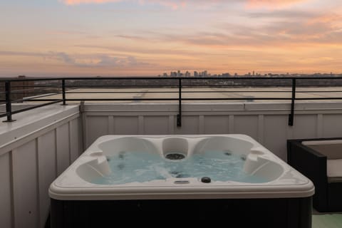 A rooftop soak with skyline views. Nights end better right here.