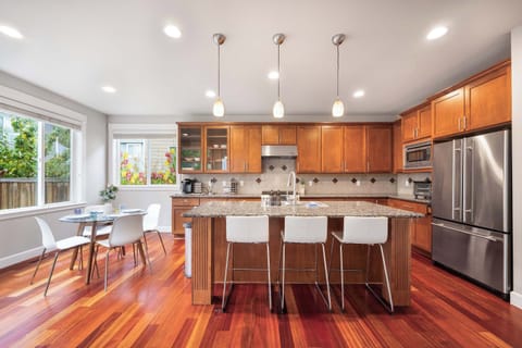 Fully equipped kitchen with stainless steel appliances and room for everyone to gather.